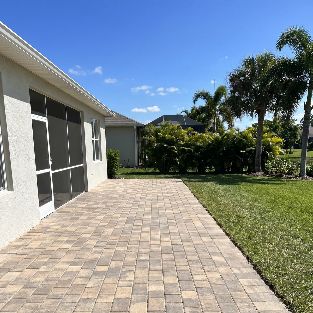 A paver patio laid in a running-bond pattern with a soldier-course border